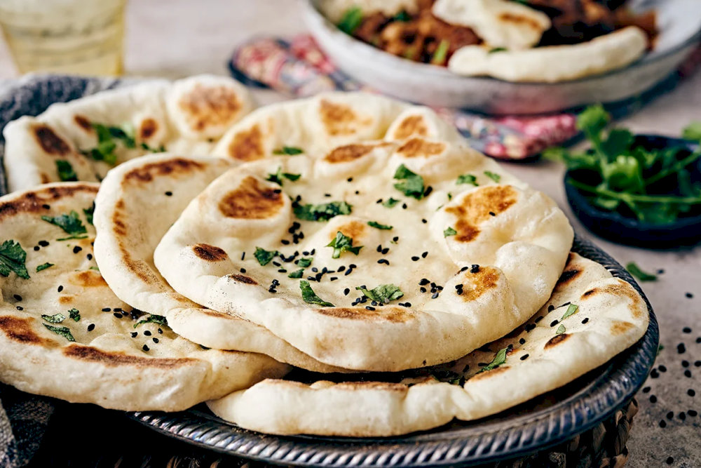 Naan is a staple in many Indian meals, often enjoyed alongside tandoori meats or vegetarian dishes